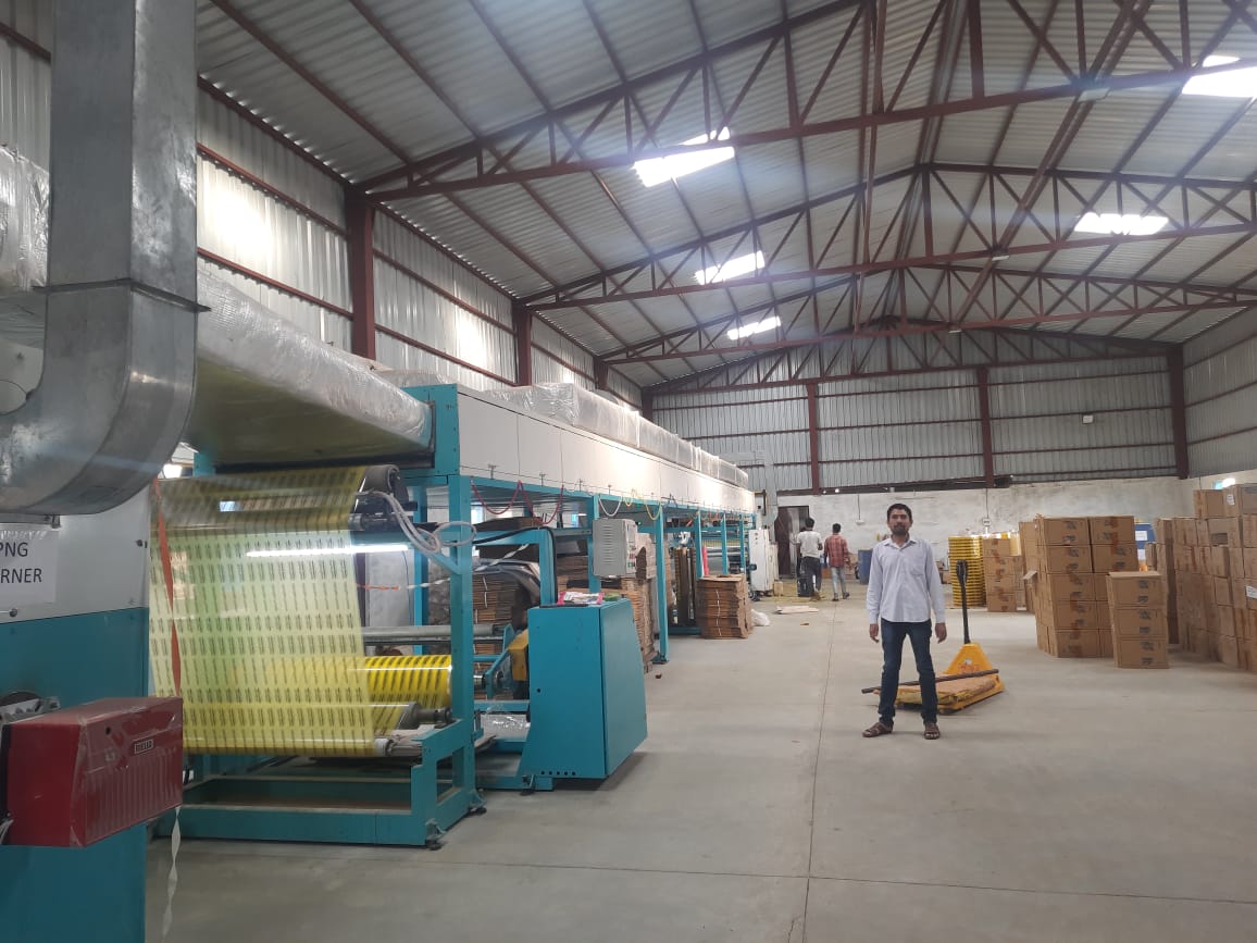 Workers handling adhesive tape production and packing